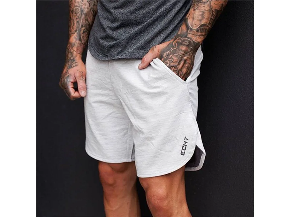 A man wearing light grey athletic gym shorts.