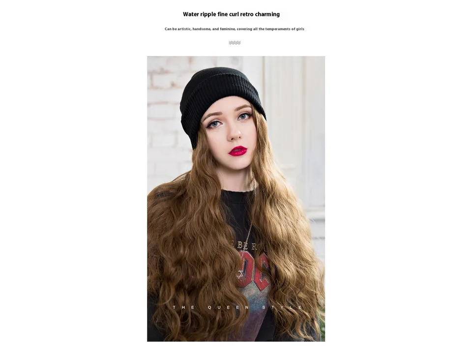 A close-up of a woman wearing the black beanie with long wavy brown hair.