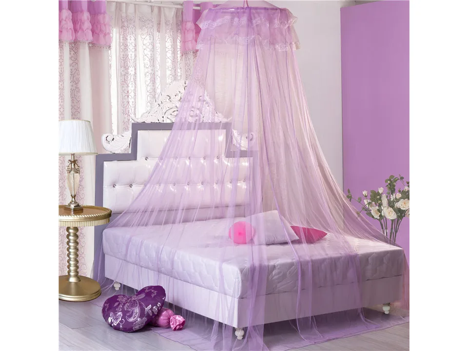 Purple hanging dome mosquito net over a bed.