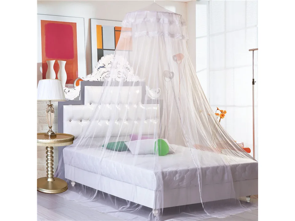 White hanging dome mosquito net over a bed.