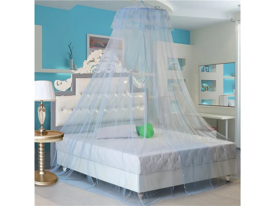 Blue hanging dome mosquito net over a bed.