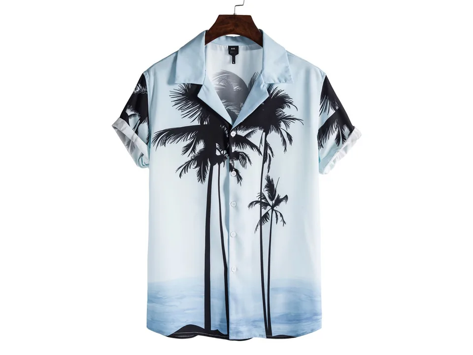 A light blue short-sleeve shirt with a black palm tree print on a hanger.