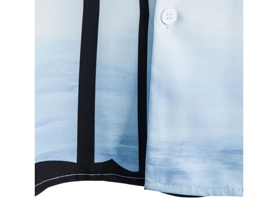 Close-up view of the light blue fabric with black palm tree print and a white button.