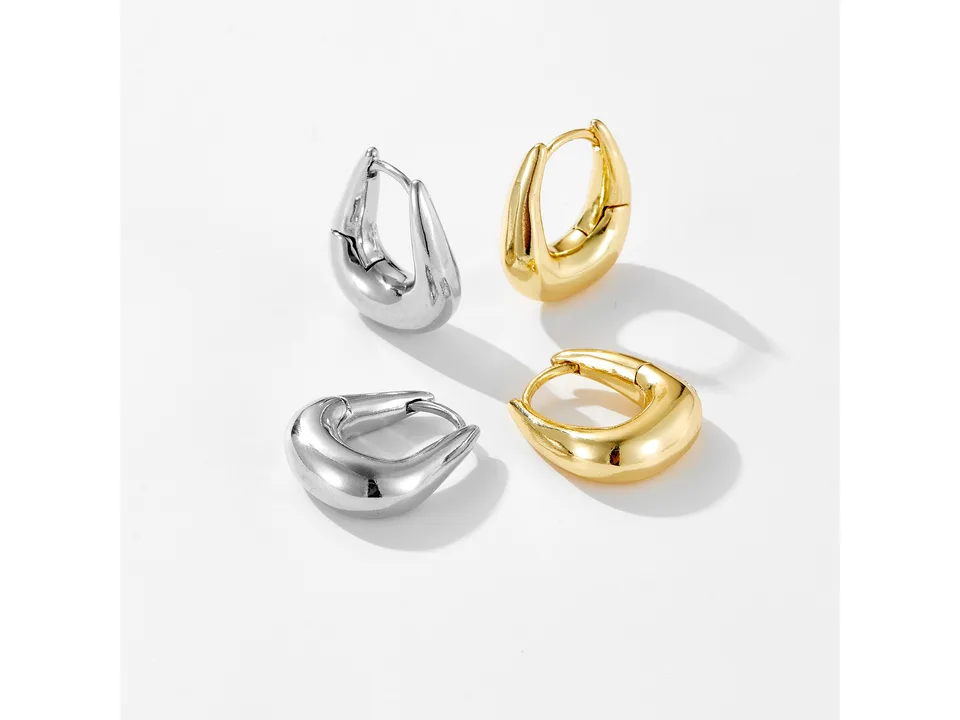 Two pairs of geometric hoop earrings, one pair in silver and one pair in gold, on a white background.