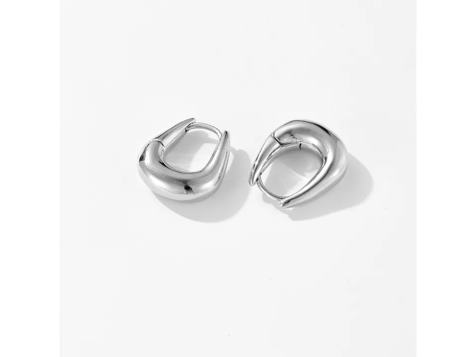 A pair of silver geometric hoop earrings shown from a side angle on a white background.