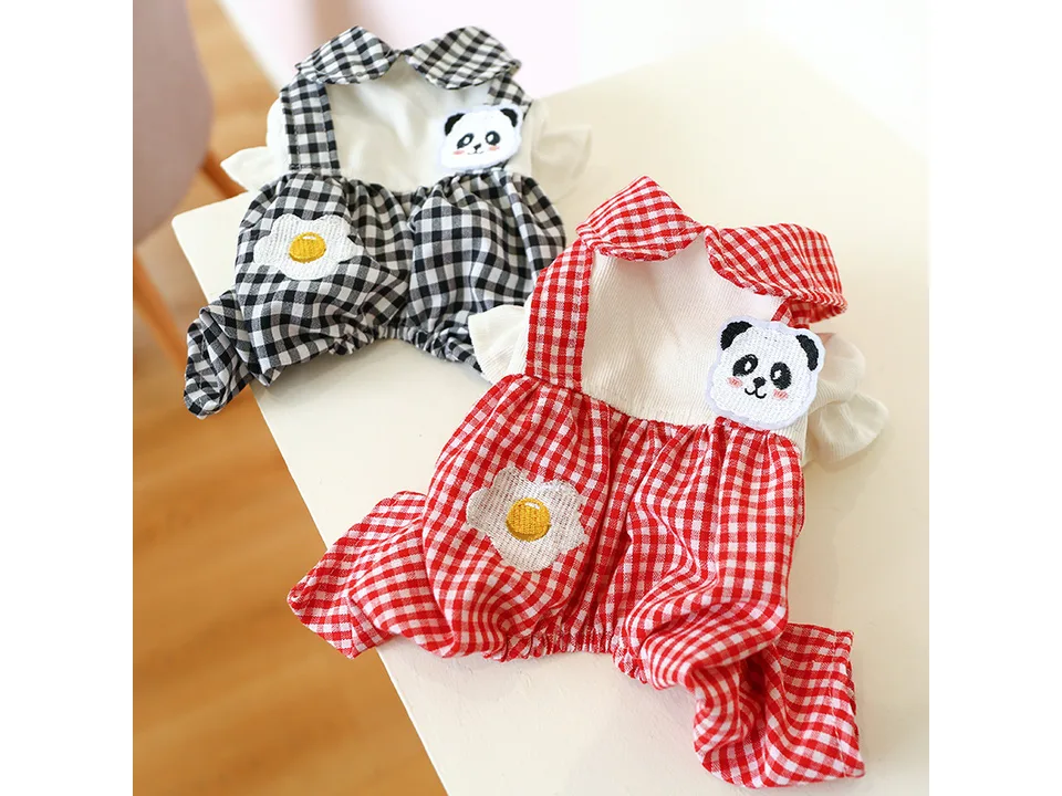 Red and black plaid dog overalls with panda and egg appliques displayed together.