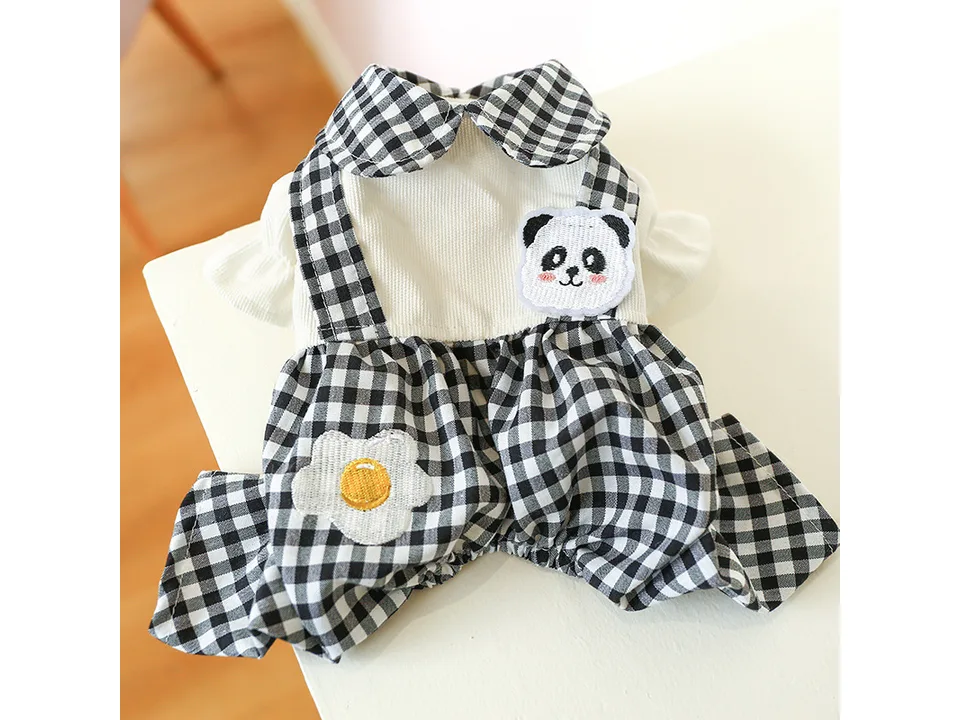 Black and white plaid dog overalls with a panda face and fried egg applique.