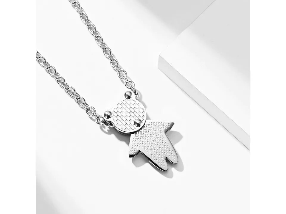 Close-up of a silver bear pendant on a chain.