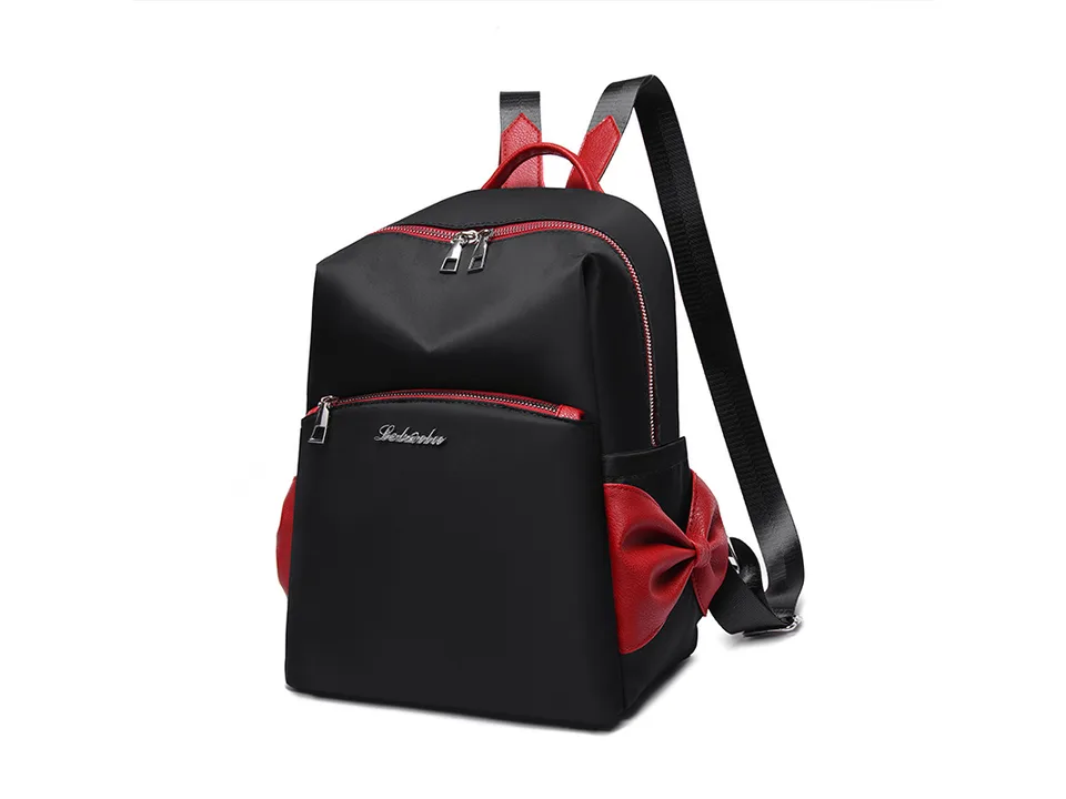 Black backpack with red bow detail and red trim