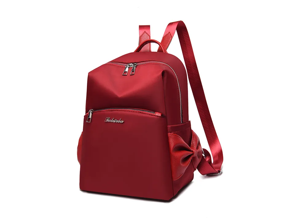 Red backpack with red bow detail