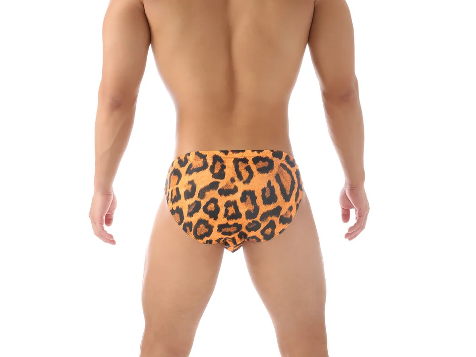 Back view of a man wearing leopard print swim briefs.