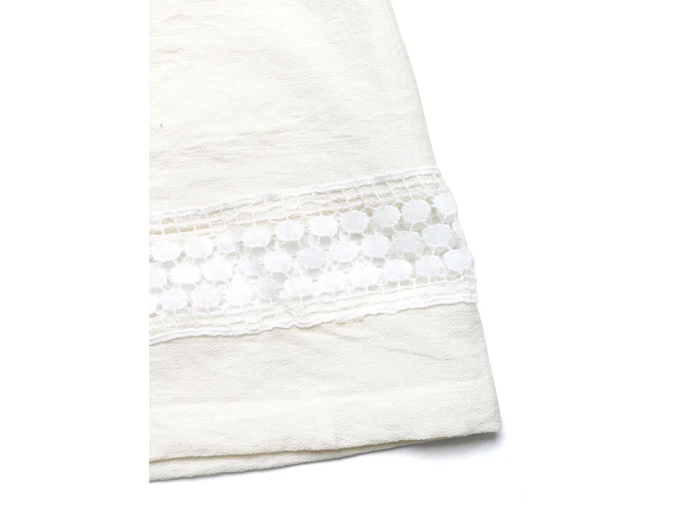 Close-up of the white lace trim detail on the hem of the pants.