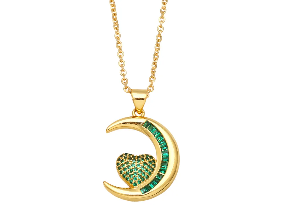 Gold necklace with a crescent moon pendant featuring green stones.