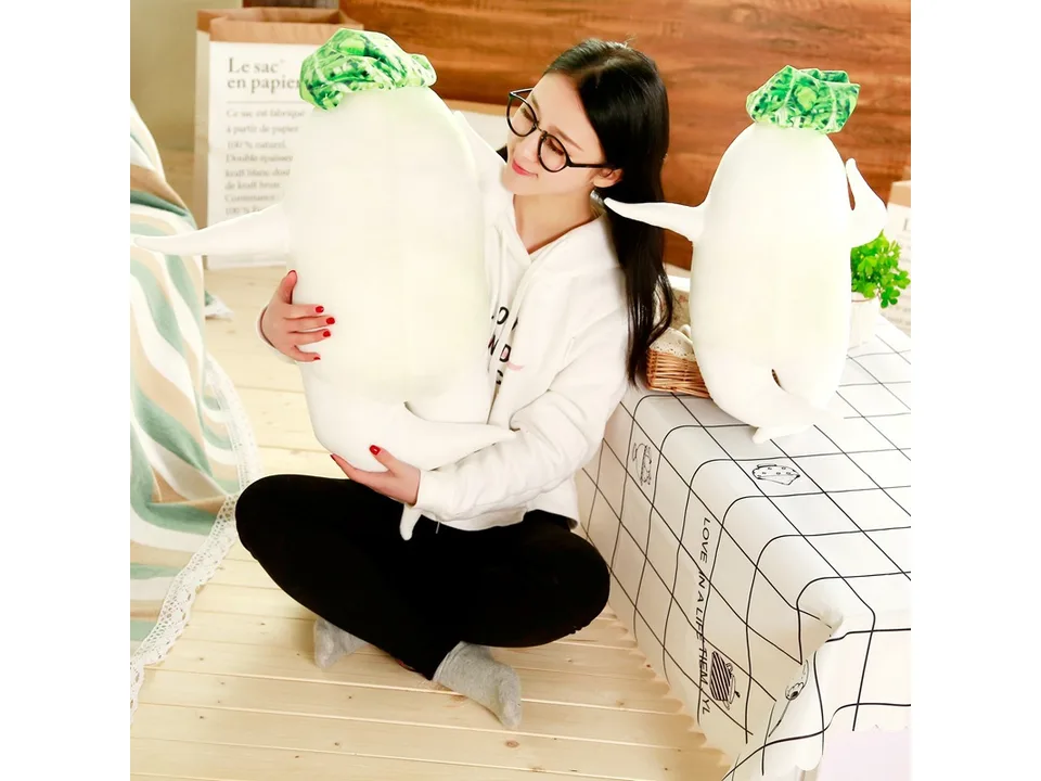 A woman holding a large white radish plush toy.