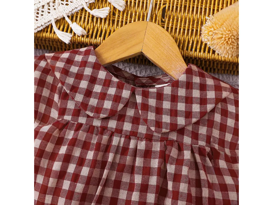 Close-up of the red and white plaid baby romper collar and fabric.