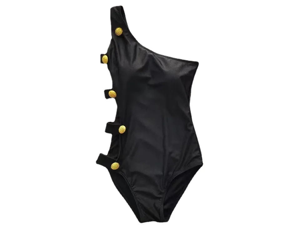 Black one-shoulder swimsuit with gold decorative buttons on the side.