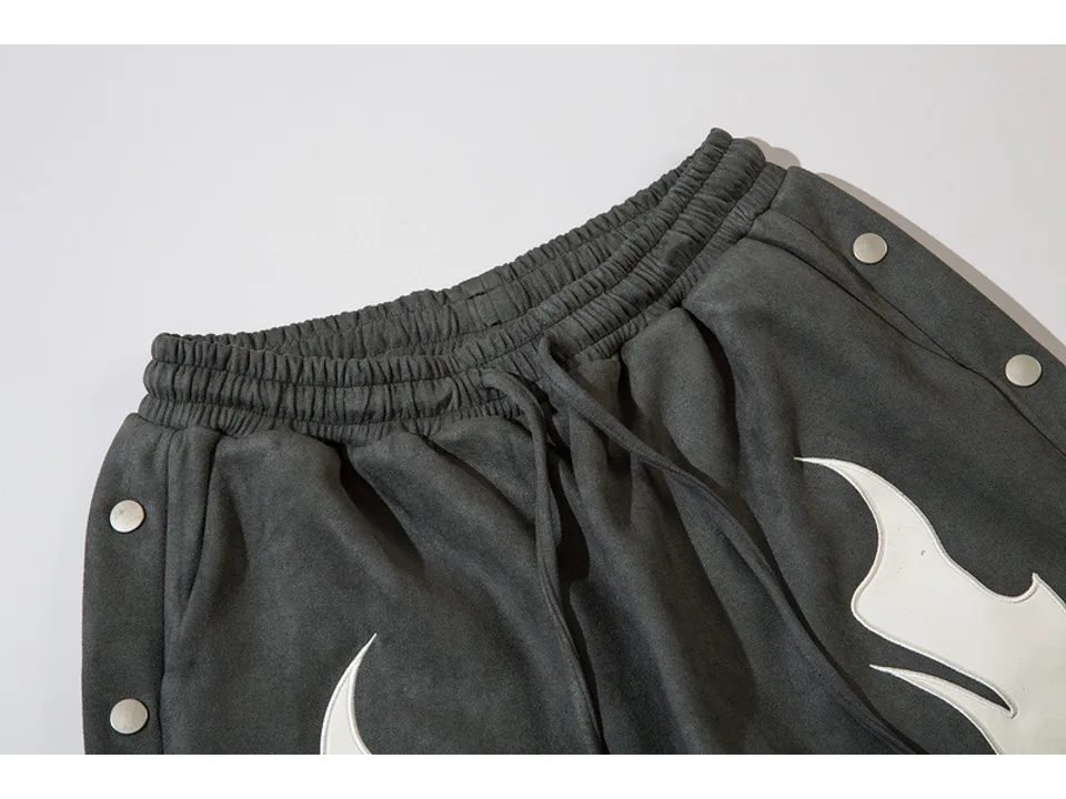 Close-up of the elastic waistband and drawstring on the grey shorts.