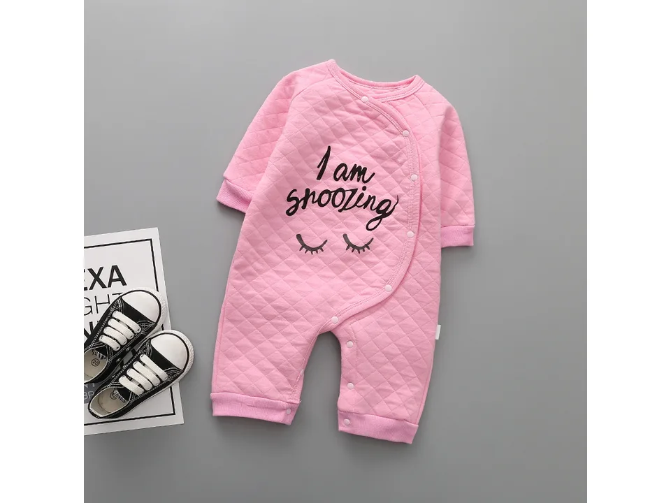 Pink quilted baby romper with 'I am snoozing' text and closed eyes graphic.
