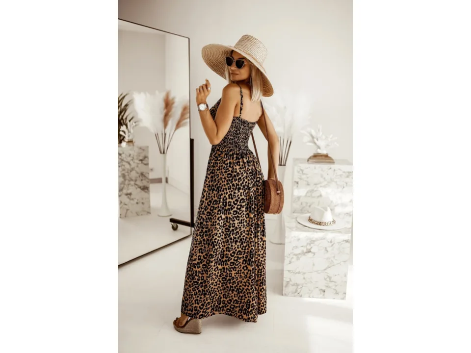 A woman seen from the back wearing a leopard print maxi slip dress.