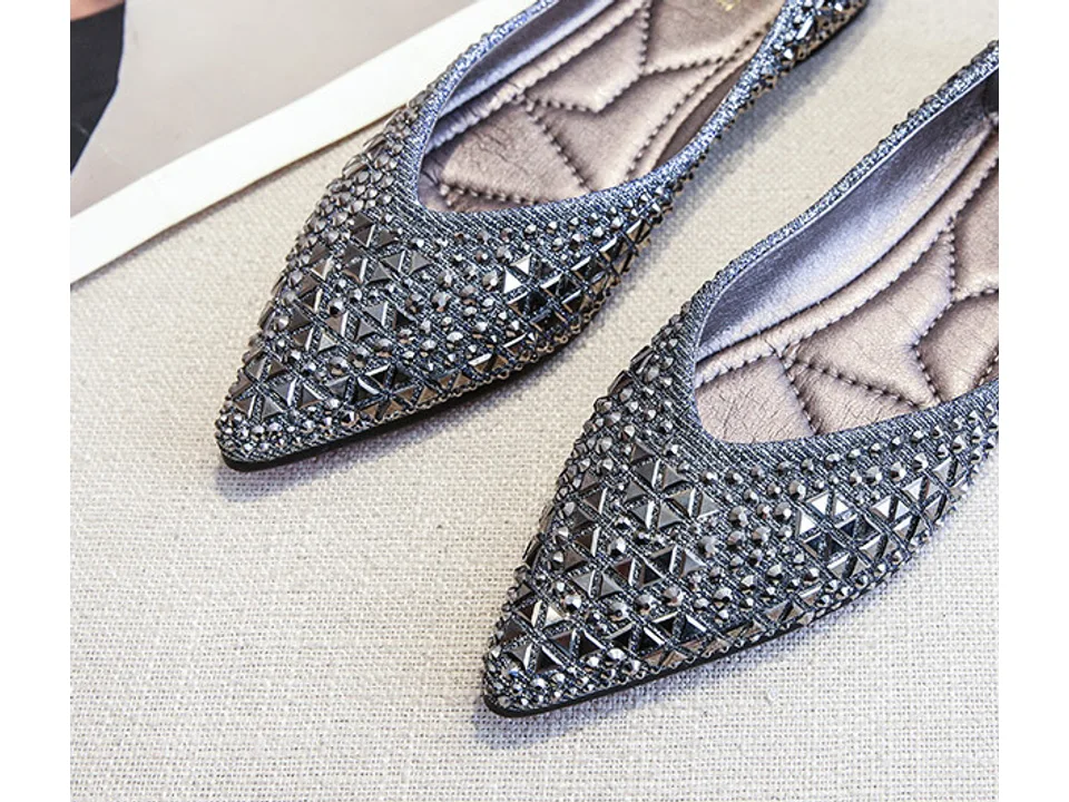 Pair of pointed-toe rhinestone flat shoes.