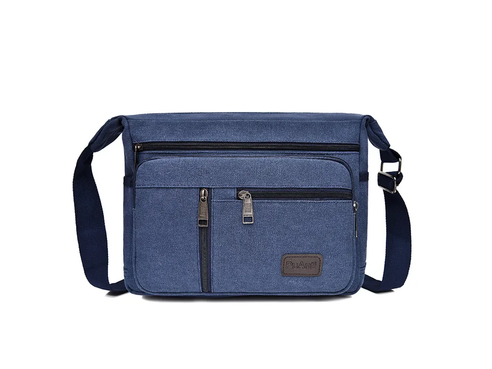 Blue canvas crossbody messenger bag with multiple zippered pockets.