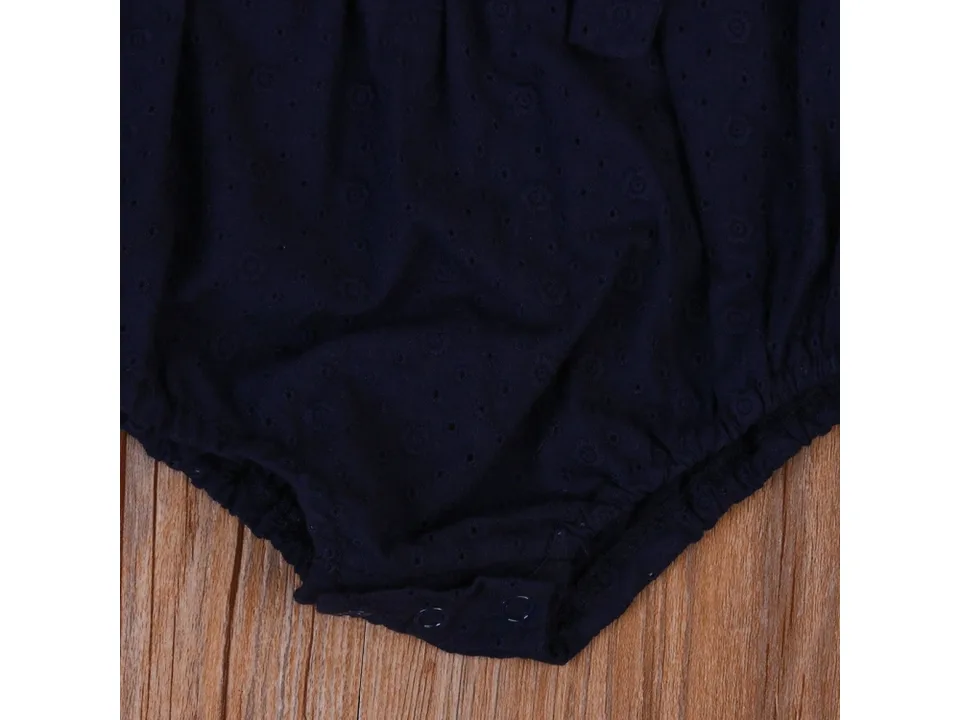 Close-up of the bottom snap buttons on a navy blue baby romper.