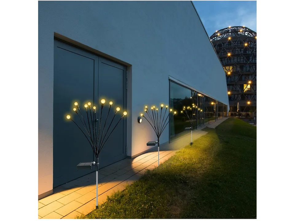Solar firefly garden lights illuminating a pathway at night.