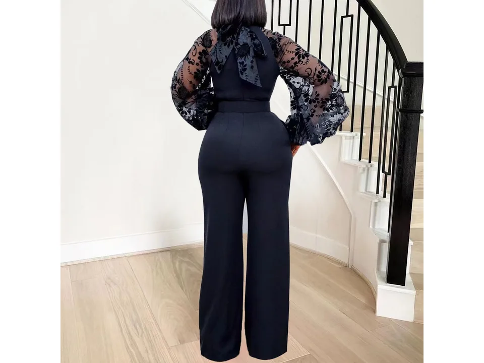 Back view of the black jumpsuit with sheer floral sleeves