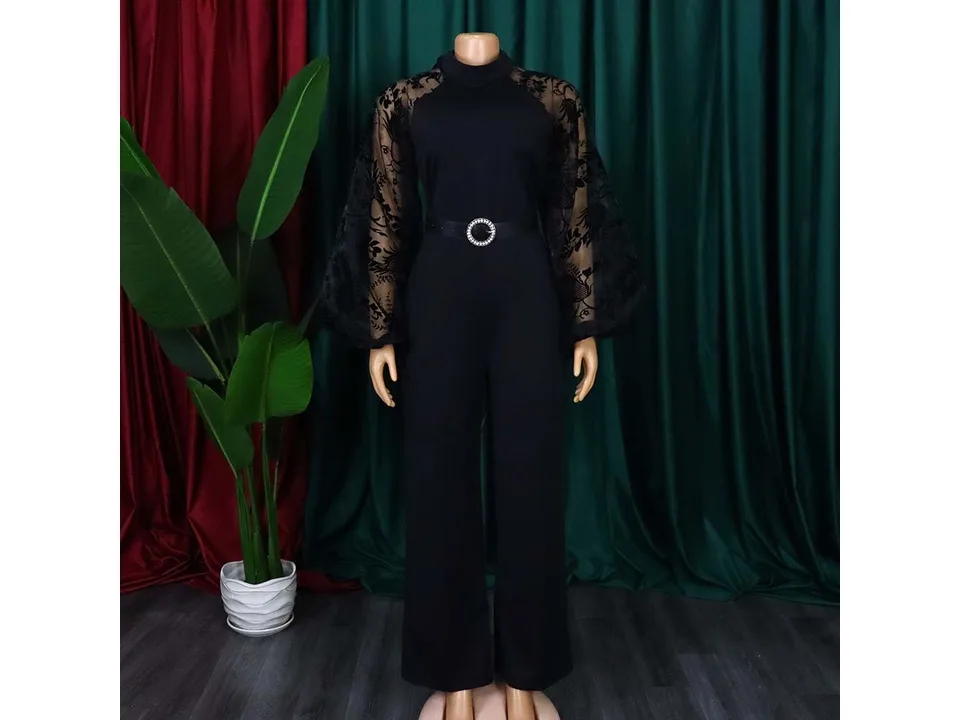 Black jumpsuit with sheer floral sleeves on a mannequin
