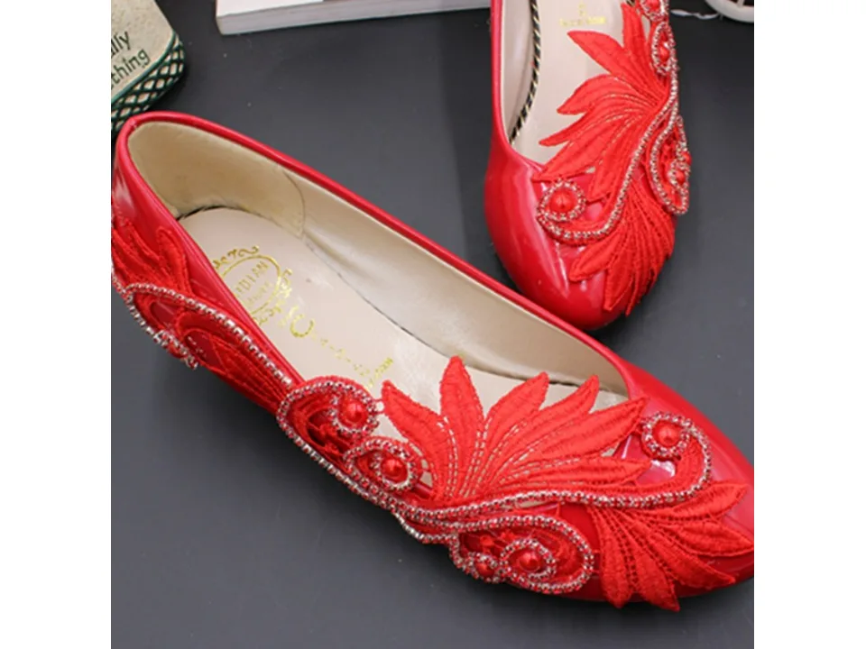 Interior view of a red bridal shoe showing the brand logo on the insole.