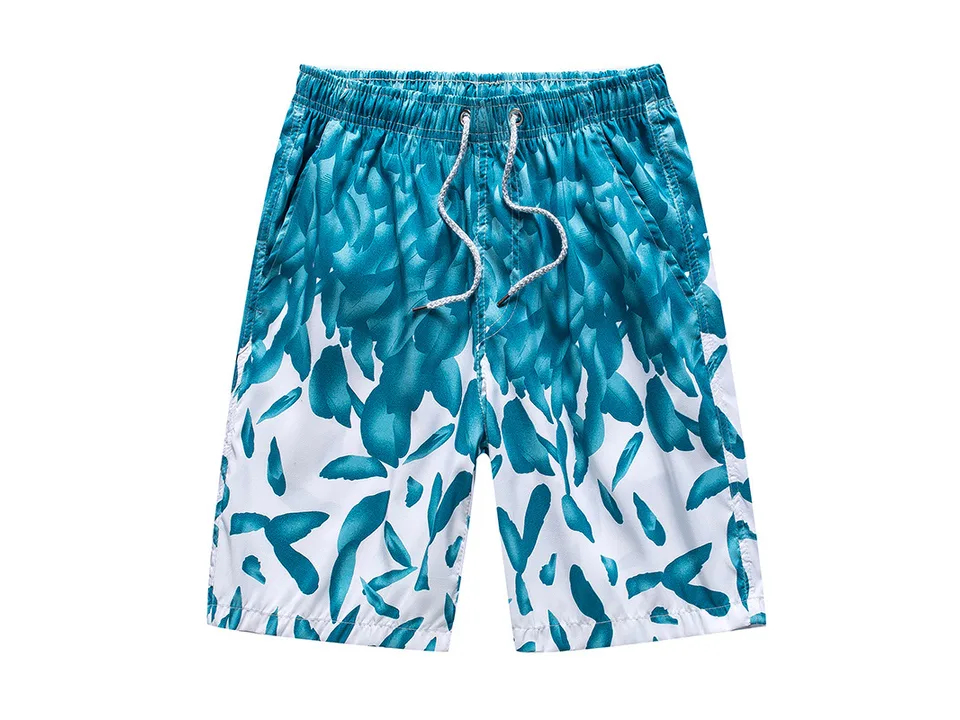 Men's board shorts with a teal and white leaf pattern.