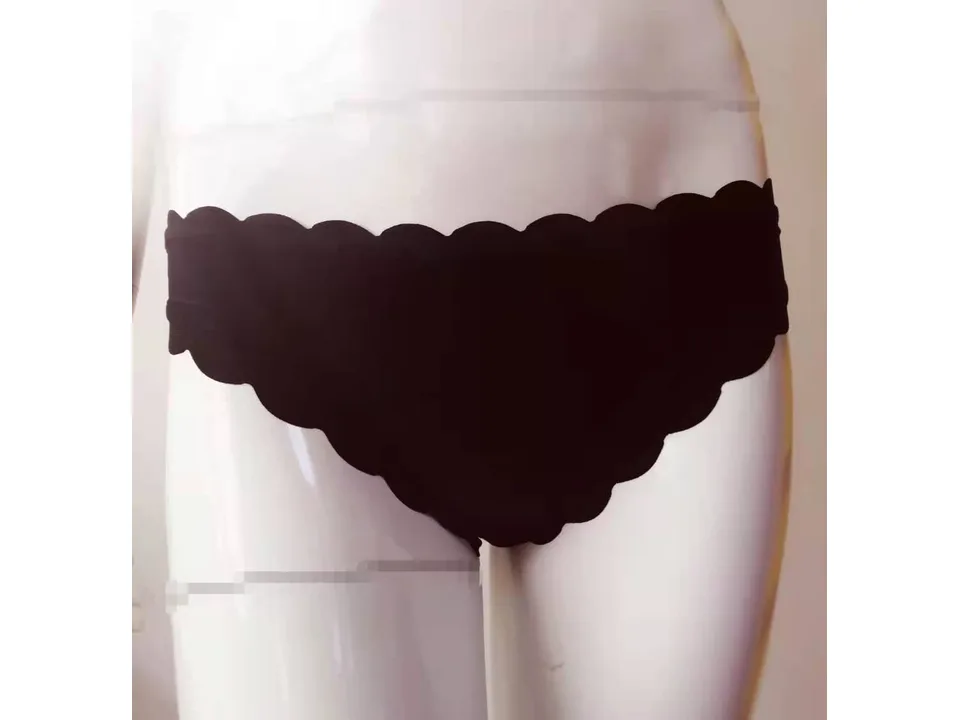 Close-up of a black scalloped bikini bottom on a mannequin.