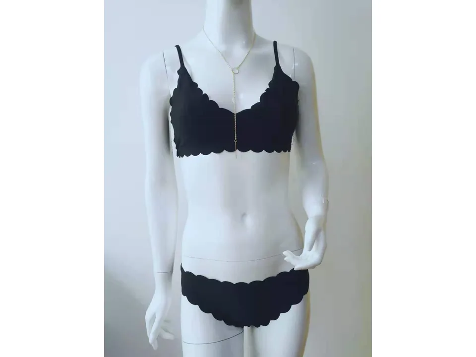 Full view of a black scalloped bikini set on a mannequin.