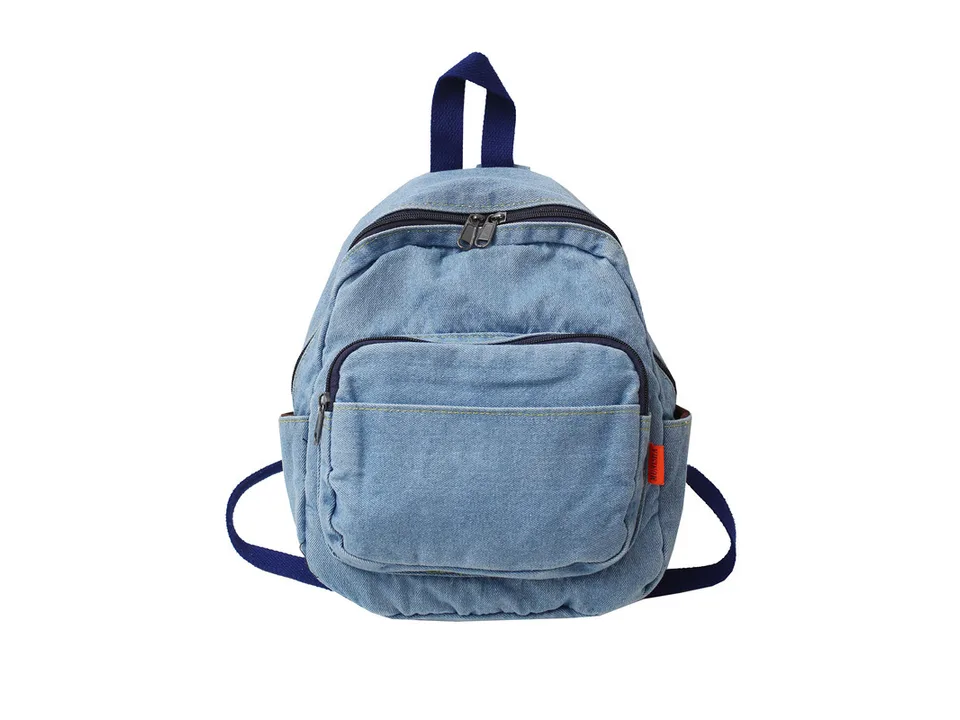 Light blue denim backpack on a white background.