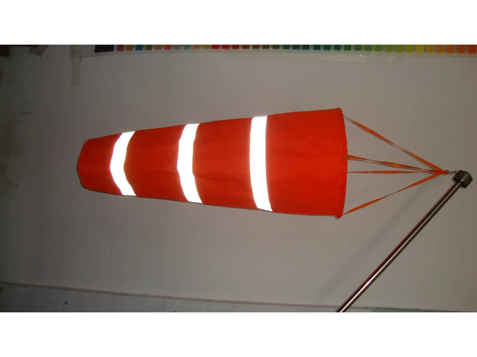 Close-up of the orange windsock showing the reflective stripes and attachment straps.