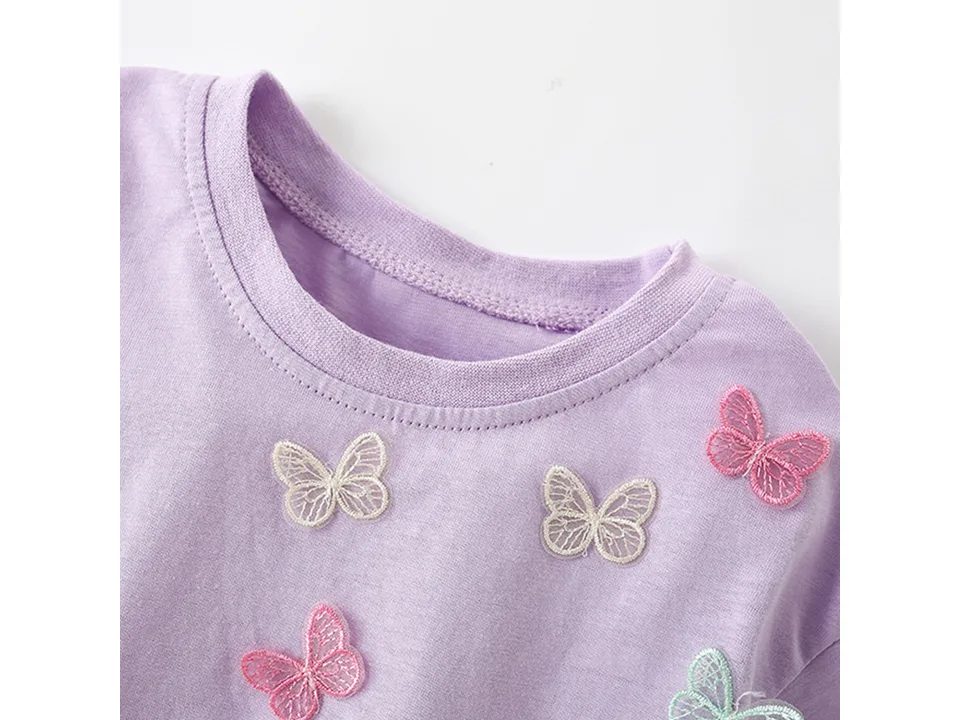 Close-up of the t-shirt neckline and butterfly details.