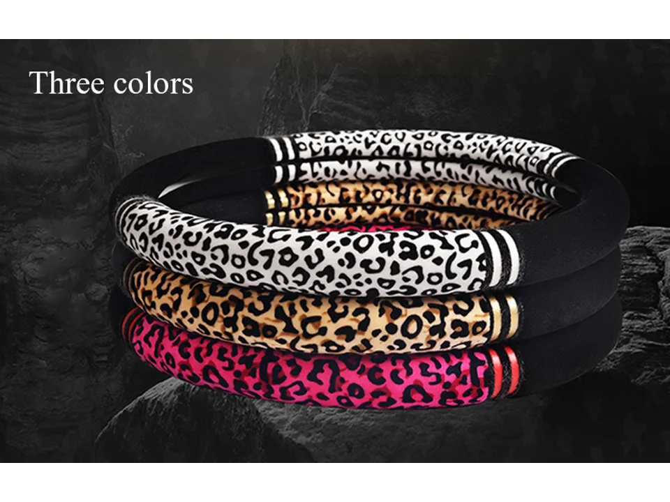 Three steering wheel covers in white, brown, and pink leopard print stacked together.