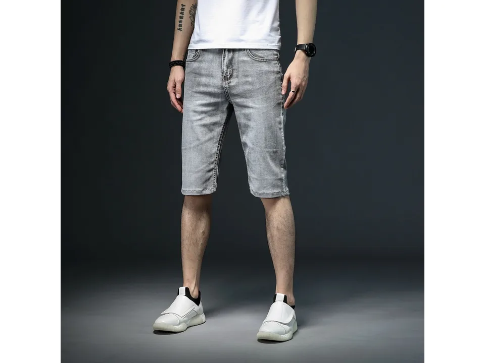 A man wearing grey denim shorts, front view.