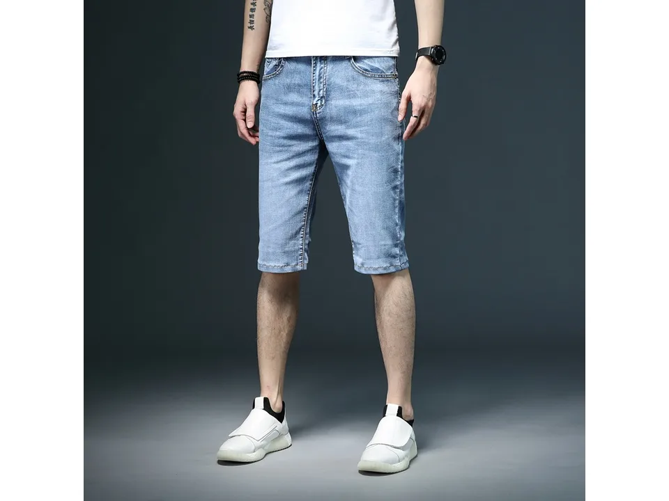 A man wearing blue denim shorts, front view.