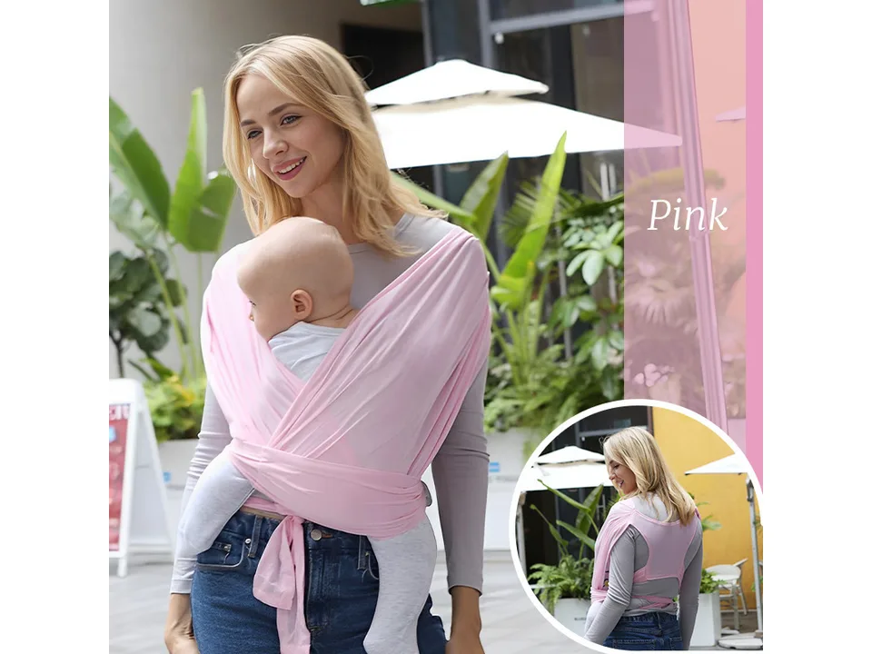 A woman wearing a grey baby wrap carrier, demonstrating its use for home and on-the-go.