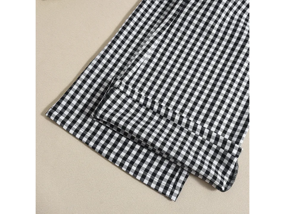 Close-up of the bottom hem of the black and white plaid jumpsuit.