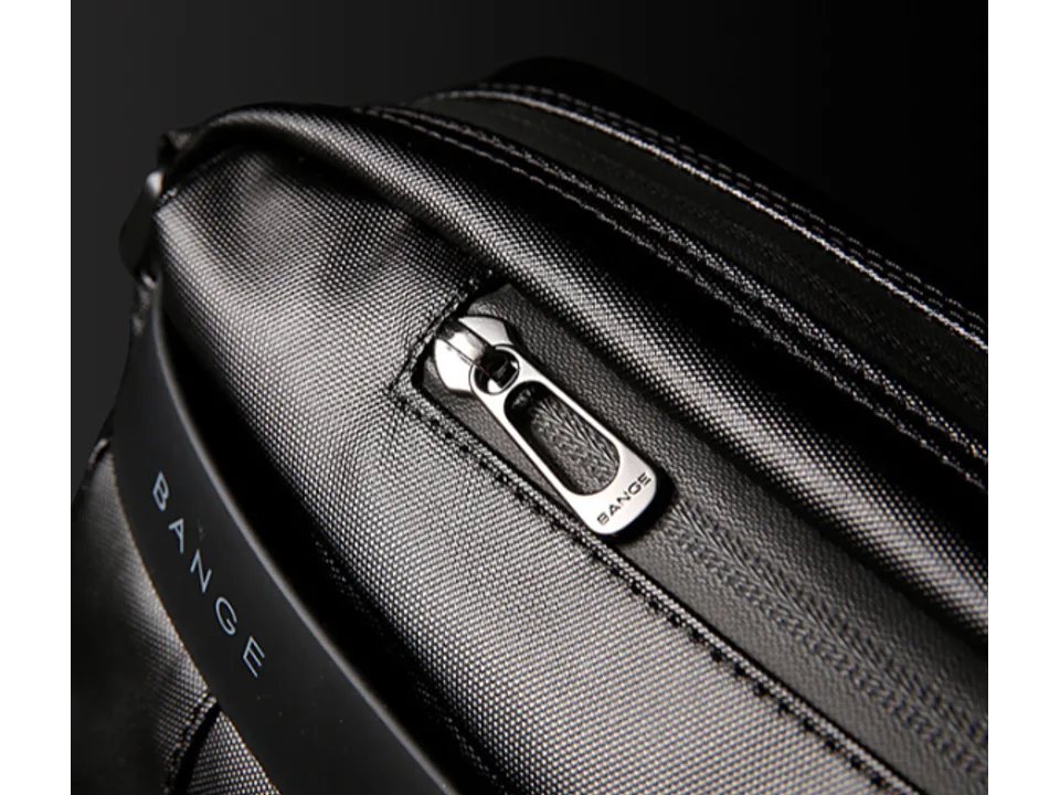Close-up of the metal zipper pull and textured fabric on the bag.