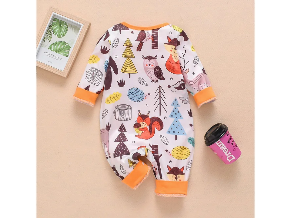 Infant coveralls with a colorful woodland animal print laid flat.