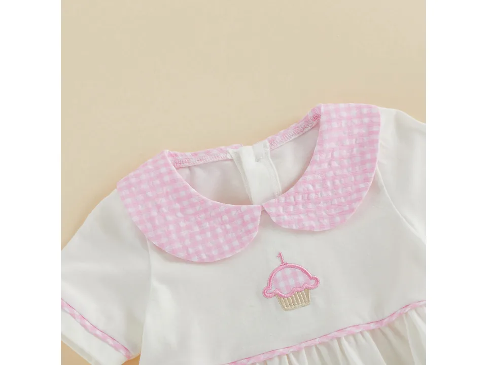 Close-up of the pink gingham collar and cupcake embroidery on the baby onesie.