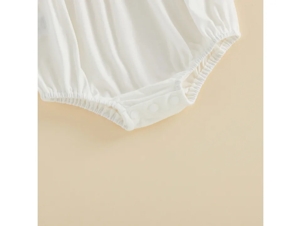Close-up of the bottom snap closure on the baby onesie.