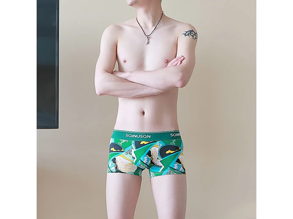 A man wearing the green patterned boxer briefs.
