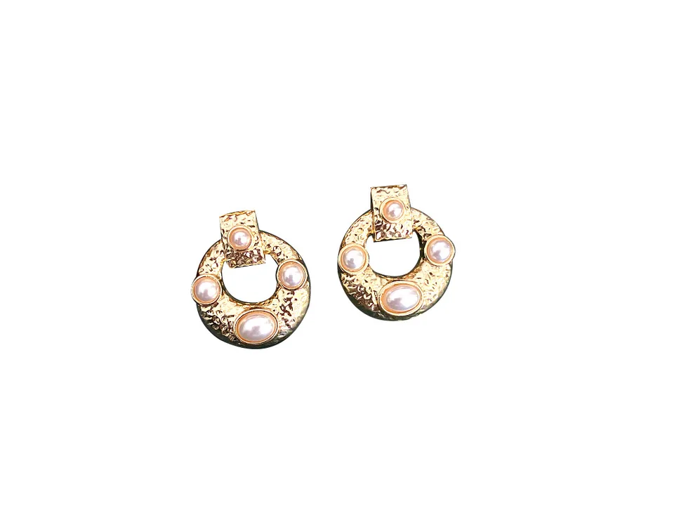 A pair of gold-tone hoop earrings with textured metal and inset imitation pearls.