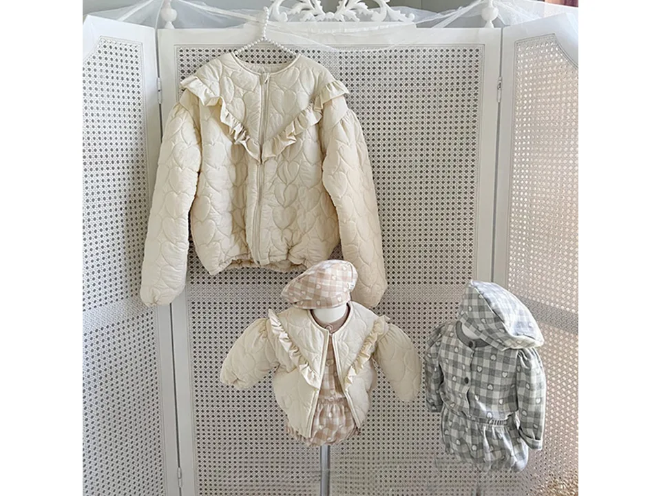 The cream quilted jacket displayed on a mannequin.