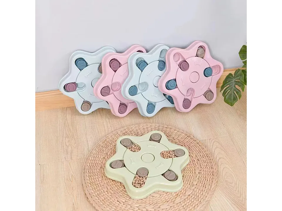 Several star-shaped dog puzzle feeders arranged on a floor mat.
