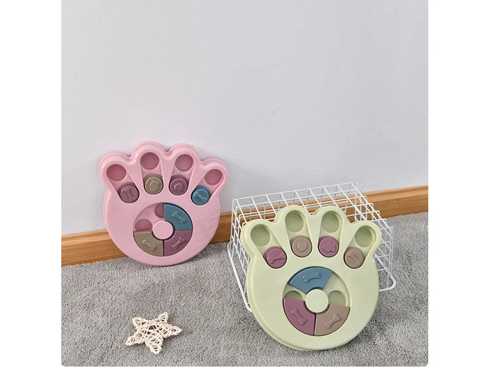 Two different paw-shaped dog puzzle feeders displayed together.